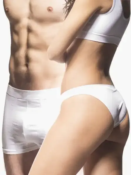 A couple's toned physique after EMSculpt treatment.